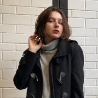 It's me standing next to the wall in the dark coat