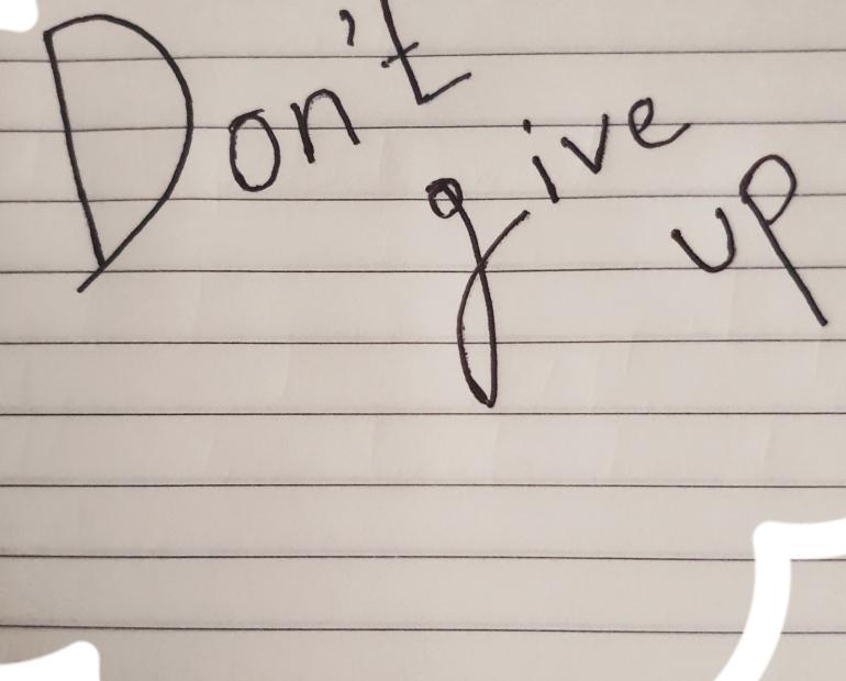 Don't give up written on a page