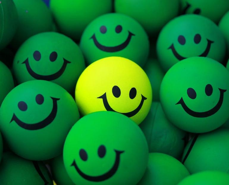 Green rubber balls with smiles.