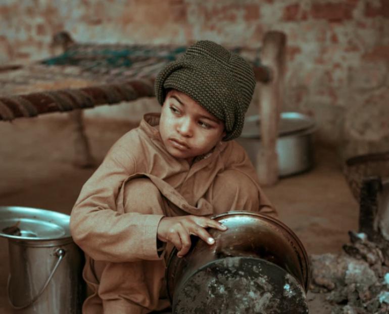 A child washing utensils