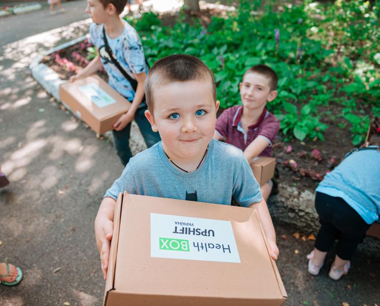 The boy is holding a Health-BOX