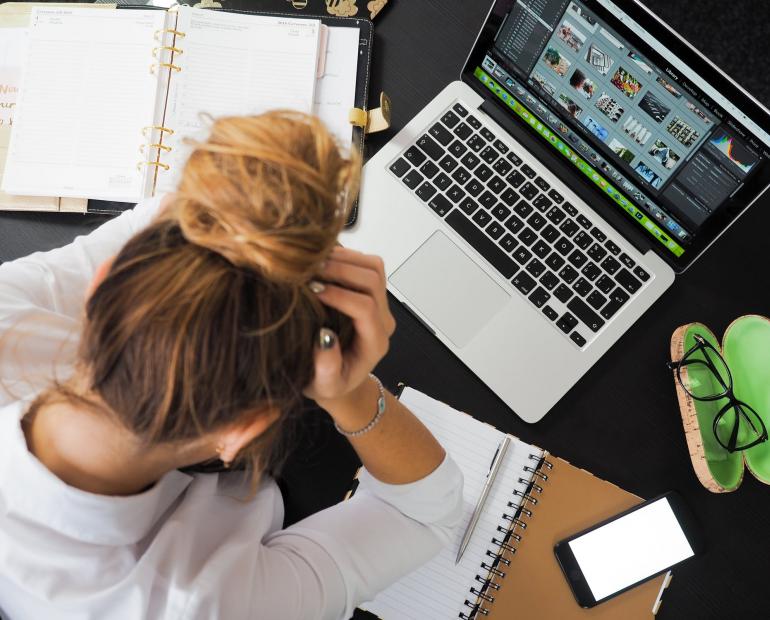 Woman Sitting in Front of MacBook
