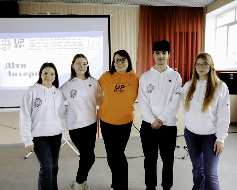 Polina's team takes a photo together during one of their events 