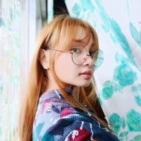 a woman, with glasses, red hair
