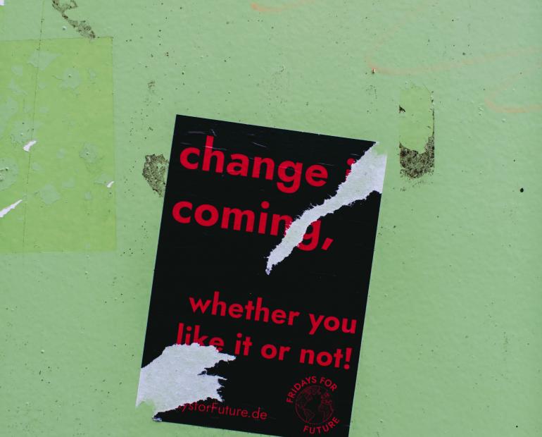 "change is coming, whether you like it or not" red text on black on pale