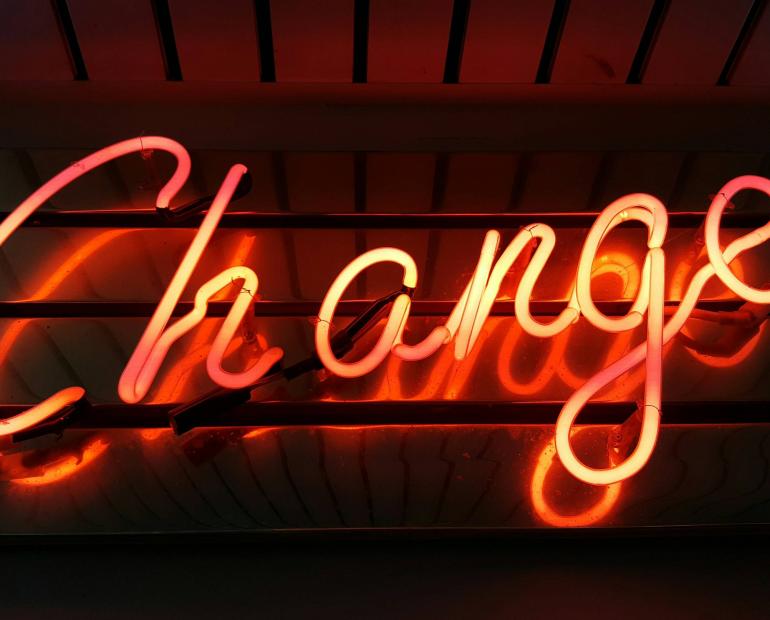 A neon light that says change