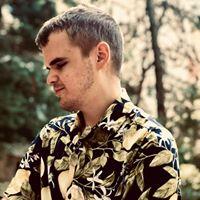 Man in a shirt in front of trees 