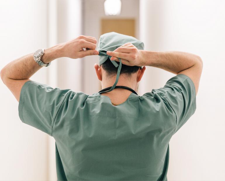 doctor tying headscarf