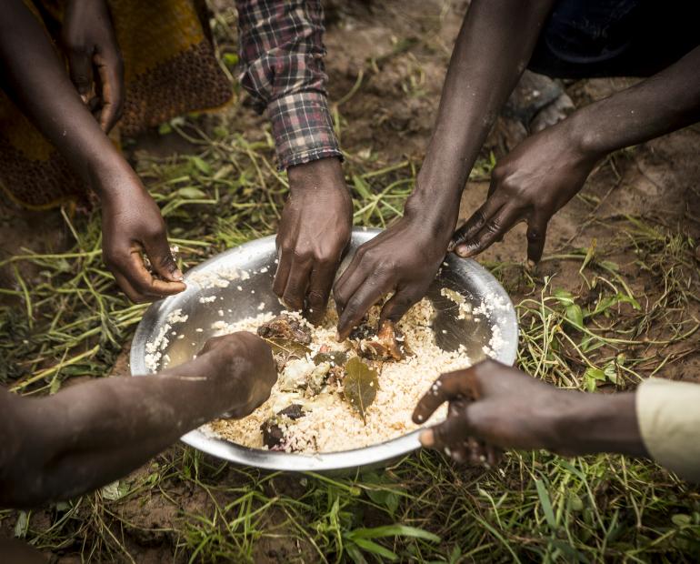 Moussa Dembele, father of three children and a farmer in Zebala village, here in his field eating with other members of his family in Mali.