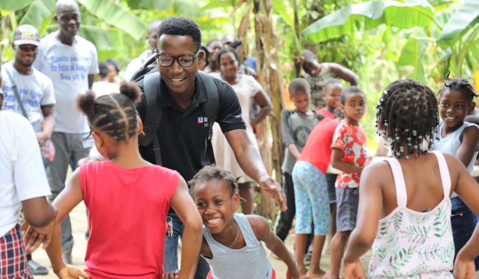 Joseph, a U-Reporter, plays with children in the IDP camps of Haiti as part of psychosocial support in UNICEF's humanitarian response.